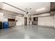 Large garage with epoxy floor, cabinets, and plenty of space for parking and storage, perfect for car enthusiasts at 3935 E Rough Rider Rd # 1183, Phoenix, AZ 85050