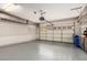 Spacious garage featuring a clean epoxy floor, overhead storage cabinets and ample room for vehicles and projects at 3935 E Rough Rider Rd # 1183, Phoenix, AZ 85050