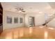 Bright living area with natural light, a ceiling fan, and access to a stairwell at 3935 E Rough Rider Rd # 1183, Phoenix, AZ 85050