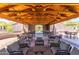 Spacious outdoor lounge area with ample seating and a beautiful wood-covered structure overhead at 3935 E Rough Rider Rd # 1183, Phoenix, AZ 85050