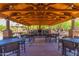 Expansive outdoor pavilion with fireplace, seating, and a wood beam ceiling, ideal for community gatherings at 3935 E Rough Rider Rd # 1183, Phoenix, AZ 85050