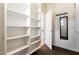 Spacious walk-in closet with custom shelving, mirror, and access to the bathroom, offering ample storage at 3935 E Rough Rider Rd # 1183, Phoenix, AZ 85050