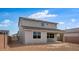 Spacious backyard showcasing the two-story home with a covered patio and side yard access at 4064 E Ghost Flower Ln, San Tan Valley, AZ 85140