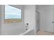 Well-lit bathroom with a tub, shower, and a large window with a view at 4064 E Ghost Flower Ln, San Tan Valley, AZ 85140
