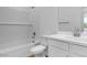 Bright bathroom featuring a tile surround tub, white vanity, and modern fixtures at 4064 E Ghost Flower Ln, San Tan Valley, AZ 85140