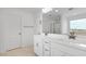 Bathroom featuring a double sink vanity and a large mirror, with white cabinets at 4064 E Ghost Flower Ln, San Tan Valley, AZ 85140