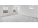 Bright and airy bedroom featuring multiple windows and neutral carpeting at 4064 E Ghost Flower Ln, San Tan Valley, AZ 85140