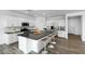 Open kitchen with white cabinets, stainless steel appliances, a large island, and stylish counter seating at 4064 E Ghost Flower Ln, San Tan Valley, AZ 85140