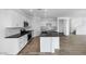 Spacious kitchen featuring white cabinets, stainless steel appliances, a center island, and wood-look floors at 4064 E Ghost Flower Ln, San Tan Valley, AZ 85140