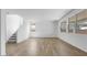 Bright living room with hardwood floors and large windows. Stairs lead to upper floor at 4064 E Ghost Flower Ln, San Tan Valley, AZ 85140