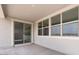 Outdoor patio area with sliding glass doors and large windows overlooking the backyard at 4064 E Ghost Flower Ln, San Tan Valley, AZ 85140