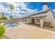 Backyard pool area featuring a covered patio, desert landscaping, and a view of the home's exterior at 4214 E Morrow Dr, Phoenix, AZ 85050
