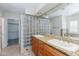 Bright bathroom featuring double sinks, granite counters and stylish glass block partition at 4214 E Morrow Dr, Phoenix, AZ 85050