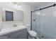 Updated bathroom featuring a glass shower, brushed gold fixtures, and a gray vanity at 4214 E Morrow Dr, Phoenix, AZ 85050