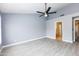 Bedroom featuring gray floors, a ceiling fan, and neutral paint, leading to the en-suite bathroom at 4214 E Morrow Dr, Phoenix, AZ 85050