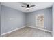 Bedroom with ceiling fan, neutral colored walls, window with blinds, and wood-look flooring at 4214 E Morrow Dr, Phoenix, AZ 85050