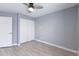 Bedroom with ceiling fan, closet with bi-fold doors, neutral walls, and wood-look vinyl flooring at 4214 E Morrow Dr, Phoenix, AZ 85050