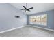 Bright bedroom with neutral walls and gray flooring, offering a view of the outdoor pool at 4214 E Morrow Dr, Phoenix, AZ 85050