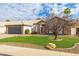 Charming one-story home featuring a lush lawn, mature landscaping, and stone facade accents at 4214 E Morrow Dr, Phoenix, AZ 85050
