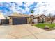 Attractive single-story home featuring a two-car garage, well-kept lawn, and desert landscaping at 4214 E Morrow Dr, Phoenix, AZ 85050