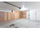 Garage with built-in storage cabinets, water heater, and door to interior of home at 4214 E Morrow Dr, Phoenix, AZ 85050