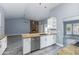 Modern kitchen showcasing a large island with granite countertop and stainless steel appliances at 4214 E Morrow Dr, Phoenix, AZ 85050