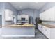 Spacious kitchen featuring white cabinetry, granite counters, and modern stainless steel appliances at 4214 E Morrow Dr, Phoenix, AZ 85050