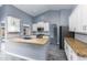 Bright kitchen boasts white cabinets, granite countertops, stainless appliances, and wood-look tile flooring at 4214 E Morrow Dr, Phoenix, AZ 85050