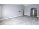 Large, open living room with wood-look tile flooring and neutral paint, ready for personalization at 4214 E Morrow Dr, Phoenix, AZ 85050