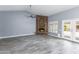 Bright living room with a stone fireplace, ceiling fan, and access to the backyard at 4214 E Morrow Dr, Phoenix, AZ 85050