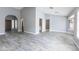 Open-concept living area features stylish gray wood-look tile floors, archways, and natural light at 4214 E Morrow Dr, Phoenix, AZ 85050