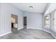 Spacious living area with wood-look tile floors and an archway to the kitchen with stainless appliances at 4214 E Morrow Dr, Phoenix, AZ 85050