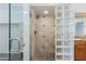 Tiled shower with glass door next to tiled wall and glass block in modern bathroom at 4214 E Morrow Dr, Phoenix, AZ 85050