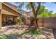 Expansive backyard with mature trees, a slide, and shaded patio area, perfect for outdoor fun at 4355 E Cullumber St, Gilbert, AZ 85234