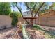 Spacious backyard featuring a slide, platform treehouse, and low maintenance rock landscaping at 4355 E Cullumber St, Gilbert, AZ 85234