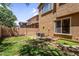 The spacious backyard features a grassy lawn and AC units, offering potential for customization at 4355 E Cullumber St, Gilbert, AZ 85234