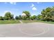 Another outdoor basketball court surrounded by green grass and trees, offering a pleasant playing environment at 4355 E Cullumber St, Gilbert, AZ 85234