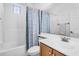 Bright bathroom featuring a shower-tub combo with blue patterned shower curtain and vanity at 4355 E Cullumber St, Gilbert, AZ 85234
