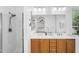Bathroom featuring a glass-enclosed shower and vanity with dual sinks at 4355 E Cullumber St, Gilbert, AZ 85234