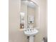 Half bath features a pedestal sink, decorative mirror and tiled floors at 4355 E Cullumber St, Gilbert, AZ 85234