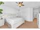 Bright bedroom features a king bed, ceiling fan, and entry into the adjacent bathroom at 4355 E Cullumber St, Gilbert, AZ 85234
