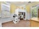 Bright bedroom includes a lofted bed with a desk, dollhouse, and chair at 4355 E Cullumber St, Gilbert, AZ 85234