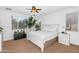 Bright bedroom with a ceiling fan, large window, plants, and carpeted floor at 4355 E Cullumber St, Gilbert, AZ 85234