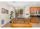 Bright dining area with a large window, wooden table with bench seating, and tile floors at 4355 E Cullumber St, Gilbert, AZ 85234