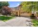 Inviting home exterior boasting a spacious driveway, mature trees, and attractive stone detailing at 4355 E Cullumber St, Gilbert, AZ 85234