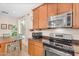Functional kitchen showcasing stainless steel appliances, wood cabinets, and a window with natural light at 4355 E Cullumber St, Gilbert, AZ 85234