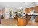 Open-concept kitchen with a central island, stainless steel appliances, and adjacent dining area at 4355 E Cullumber St, Gilbert, AZ 85234