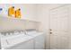 Functional laundry room features a washer, dryer, and shelving for ample storage space at 4355 E Cullumber St, Gilbert, AZ 85234