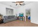 Cozy living room features plush carpeting and a ceiling fan for comfort and style at 4355 E Cullumber St, Gilbert, AZ 85234
