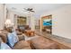 Spacious living area featuring a ceiling fan, large windows, and an open layout at 4355 E Cullumber St, Gilbert, AZ 85234